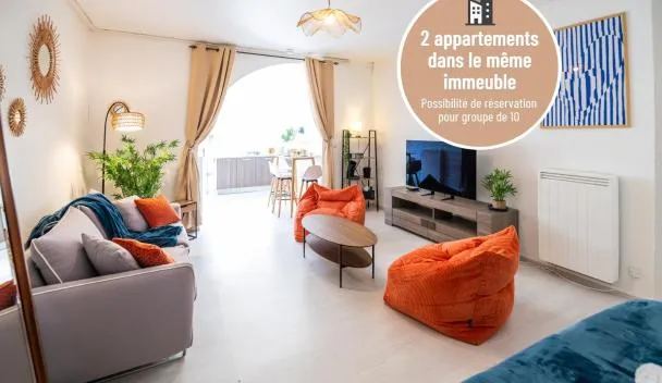 Open-plan living/dining with sofa, orange beanbags, TV, dining table and striped curtains; text: 2 appartements dans le même immeuble at L'Océane Parking gratuit Netflix Centre ville in Guebwiller