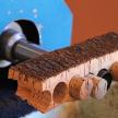a wooden train is being cut with a machine