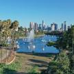 a view of a lake with a fountain and a city