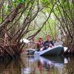 two people in a kayak on a river in the water
