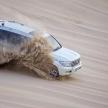 a white suv driving through the mud in the desert