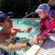 a man and a little girl in a swimming pool
