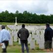 a group of people standing in a cemetery