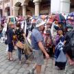 a group of people standing in front of a market