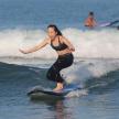 a woman riding a wave on a surfboard in the ocean