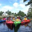 a group of people in kayaks on a river