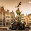 a statue in the center of a city with buildings
