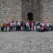 a group of people standing in front of a castle