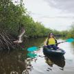 a woman in a kayak on a river