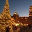 a christmas tree in front of a building with a clock tower
