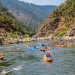 a group of people kayaking down a river in kayaks