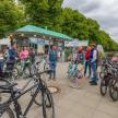 a group of people standing in front of a food stand with bikes