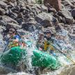 a group of people in a raft in a river