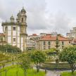 a large building with a clock tower in a city