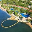 an aerial view of a resort next to the water