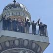 a group of people standing on the top of a lighthouse