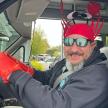 a man wearing a red hat and gloves in a car