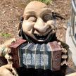 a statue of a man holding an accordion