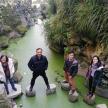 a group of people standing on rocks in a river
