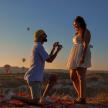 a man and a woman taking a picture of hot air balloons