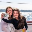 a man and a woman taking a picture on a boat