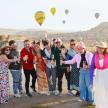 a group of people posing for a picture with wine glasses