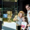 a group of people looking at a trophy in a display case