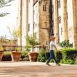 a young boy walking in front of a building