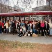 a group of people standing in front of a bus