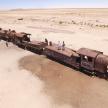 an old train in the middle of the desert