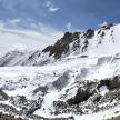 a mountain covered in snow with rocks and snow