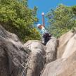 a young boy is climbing on the rocks