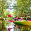 a woman and a child in a kayak on a river