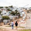 a man and a woman walking down a dirt road
