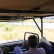 a group of people riding on a safari bus