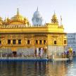 a woman standing in front of a golden temple