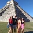 a group of people standing in front of a pyramid