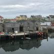 a group of houses on the water next to a dock