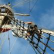 a man climbing on the rigging of a pirate ship
