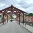 a large wooden bridge with people walking on it