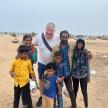 a man and his family standing on the beach