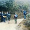 a group of people standing on a dirt trail