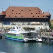 a boat docked at a pier in front of a building