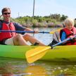 a man and a boy in a kayak on the water