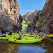 a group of people in kayaks on a river