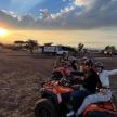 a group of people riding on atvs in a field