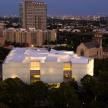 a large white building in a city at night