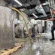 a man standing in a factory with a hose