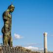 a statue of a woman standing next to a monument