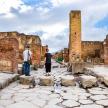 two people standing in the ruins of a building